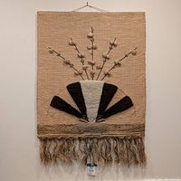 Full front view of the large woven fiber art wall hanging showing overall design and tassels.