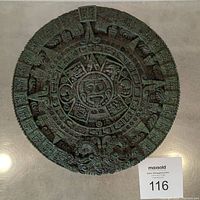Top front view of the large circular carved wall calendar, showing intricate Mayan Aztec design motifs and green malachite material.