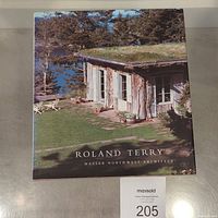 Cover of the book showing a house with green roof and landscaping by water.