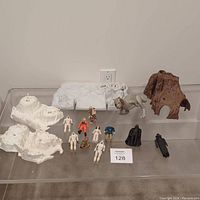 Full view of all items in the lot including Star Wars land model pieces and figures