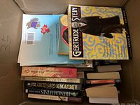 Box with assortment of books showing titles such as Gertrude Stein and French Wines.