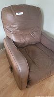 Front angled view of brown leather manual recliner showing padded arms and backrest.