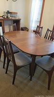 Overall view of walnut mid-century modern dining table with six matching chairs