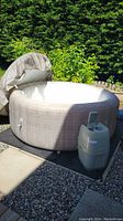 Inflatable spa and pump unit set up outdoors