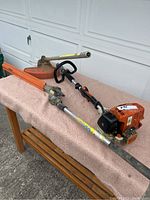 Power head and two attachments laid flat on padded surface