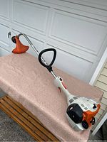 Side view of full Stihl FS 40C string trimmer showing the shaft, handle, and cutting head.