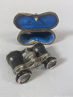 Leather bound vintage opera binoculars with blue velvet lined case open showing binoculars