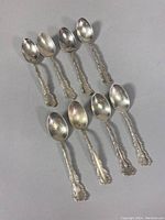 All 8 vintage Birks sterling silver espresso spoons laid out showing overall design and size
