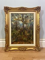 Full view of framed oil painting depicting forest scene with trees and path under the cloudy sky