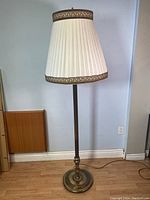 Full view of vintage double-light brass floor lamp with fabric shade, showing height and overall condition.