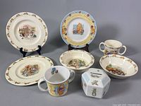 Photo showing all items: 3 Bunnykins dishes, Peter Rabbit coin bank, Winnie the Pooh cup and plate