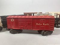 Close-up photo of red Baby Ruth candy boxcar with detailed markings and sliding door.