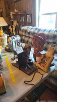 Western Western-themed area with metal boot bookends, boot candle holder, boot vase, and other Western decorative items on a table.