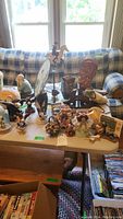 Overview of the table holding various figurines including Snoopy, eagles, vase, and other decorative items