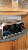 Front view of Panasonic microwave model NN-SD377S with glass door and control panel.