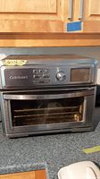 Front view of the Cuisinart airfryer toaster oven showing digital control panel, door, and overall condition.