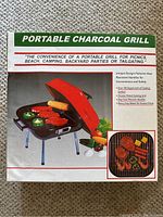 Photo of the boxed portable charcoal grill showing product image and features on the packaging.