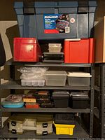 Photo of various stacked tool and storage boxes on shelves including blue Mastercraft, red and orange boxes, and clear plastic organizers.