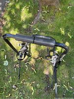Top view of the metal bike rack showing padded foam on bars and adjustable straps with buckles.