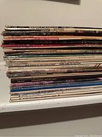 Stack of approximately 17 vinyl LP records showing spines with titles such as New Riders of the Purple Sage – Gypsy Cowboy, Steve Martin – A Wild and Crazy Guy, Gordon Lightfoot, Phoebe Snow, Steve Martin – Let’s Get Small
