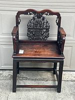 Front elevation showing carved crest rail, seat and stretcher base