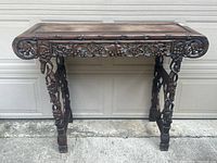 Full front view of console table showing carved apron and legs
