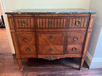 Full front view showing three small upper drawers and three larger lower drawers under marble top