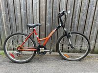 Full side view of red and black Raleigh Matterhorn ladies mountain bike showing frame, wheels, and drivetrain.