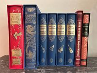 Eight Folio Society editions upright in slipcases showing spines