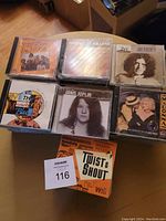 Displayed front covers of several classic music CDs including Joe Cocker, Janis Joplin, Madonna, Moody Blues, The Killers, and Stephen Stills