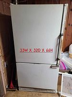 Front view of the older white refrigerator with bottom freezer, showing dimensions: 33 inches wide, 32 inches deep, 66 inches high.