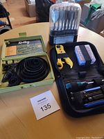 Overview of the coax cable crimper kit components including drill bits, crimper tool, and cordless screwdriver.