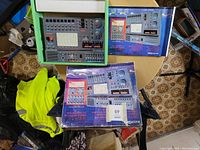 Photo showing the main project lab unit on a table along with two colorful instructional booklets for the Radio Shack 300-in-1 Electronic Project Lab.