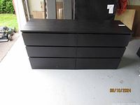 Front view of black IKEA 6-drawer set showing two columns of three drawers each with flat drawer fronts