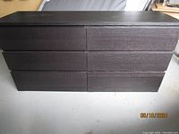 Black IKEA 6-drawer dresser, front view showing all drawers, black wood grain finish.