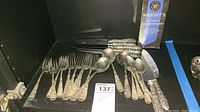 Overview of all sterling silver utensils and silver polish in single display