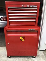 Front view of assembled rolling tool cabinet showing top chest and base, brand logos