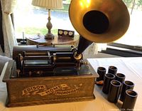 Full view of phonograph with seven cylinders