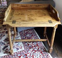 Front view of table showing removable tray top and turned legs