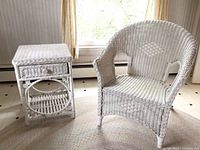 Photo showing the full view of the white wicker chair with woven diamond pattern, the matching side table with drawer and lower shelf on a braided round rug.
