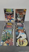 First photo showing 7 Star Trek comic books with colorful covers featuring characters and starships.