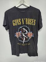 Front view of black vintage Guns N' Roses T-shirt with yellow text and graphic print.