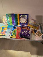 Wide shot of entire lot showing multiple early reading books arranged side-by-side, colorful covers featuring Fly Guy, Mercer Mayer, Robert Munsch titles, and SmartyPants cards set in yellow box.