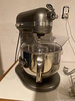 Front angle view of tilt-head mixer assembled with bowl and pouring shield