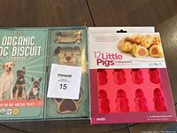 Photo of dog biscuit cookbook, silicone pig mold, and cookie cutters in packaging.