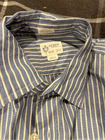 Close-up photo of a light blue and white striped J.Crew dress shirt collar and label showing size Small and made in Haiti.