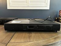 Front view of the radio tuner/cassette deck unit showing digital display, Mode and Tune controls, cassette slot and front panel labeled "Radio"