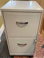 Front view of a light gray 2 drawer filing cabinet showing the handles and lock on bottom drawer.