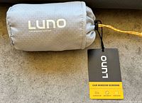 Luno car window screen rolled in gray pouch with Luno brand tag and packaging label