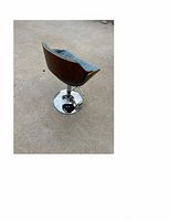 Side angle view showing walnut back, blue cloth seat, chrome base with footrest and adjustable height mechanism